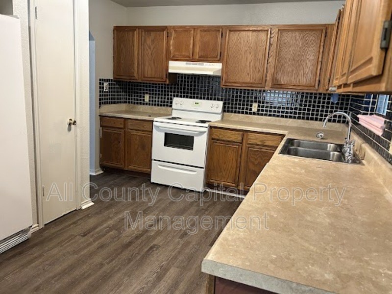 1128 Field Street San Marcos, TX 78666 - Photo 4 of 5 a kitchen with a stove a sink and a microwave