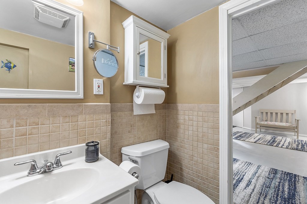 24 Sandy Beach Road Salem, NH 03079 - Photo 33 of 42 a bathroom with a sink mirror and toilet