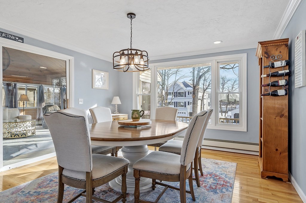 24 Sandy Beach Road Salem, NH 03079 - Photo 4 of 42 a dining room with furniture wooden floor a chandelier and a rug
