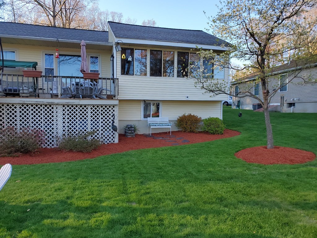 24 Sandy Beach Road Salem, NH 03079 - Photo 41 of 42 a front view of a house with a yard table and chairs