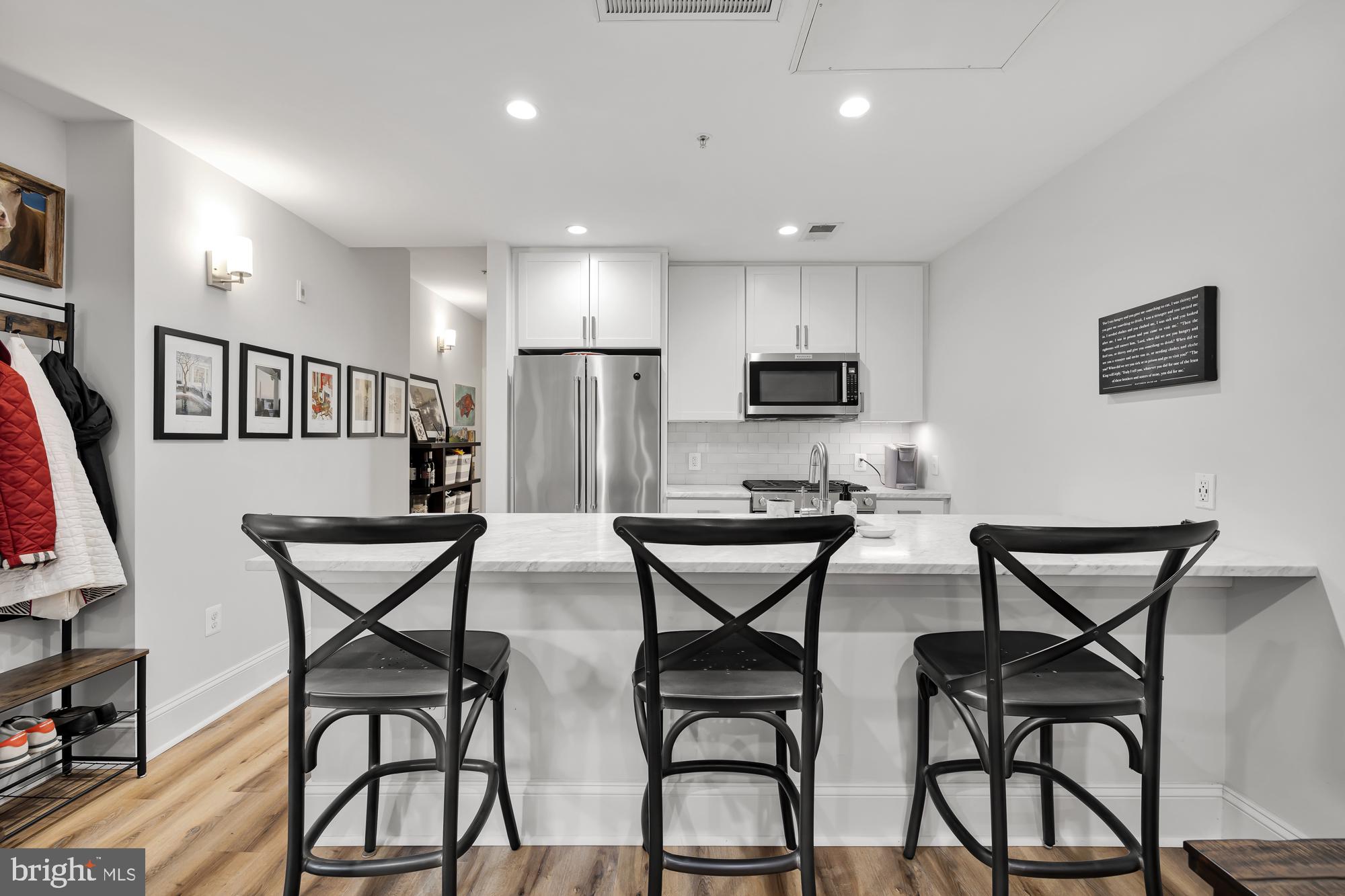 819 D Street Northeast, Unit 8 Washington, DC 20002 - Photo 12 of 26 a view of a dining room with furniture and a flat screen tv