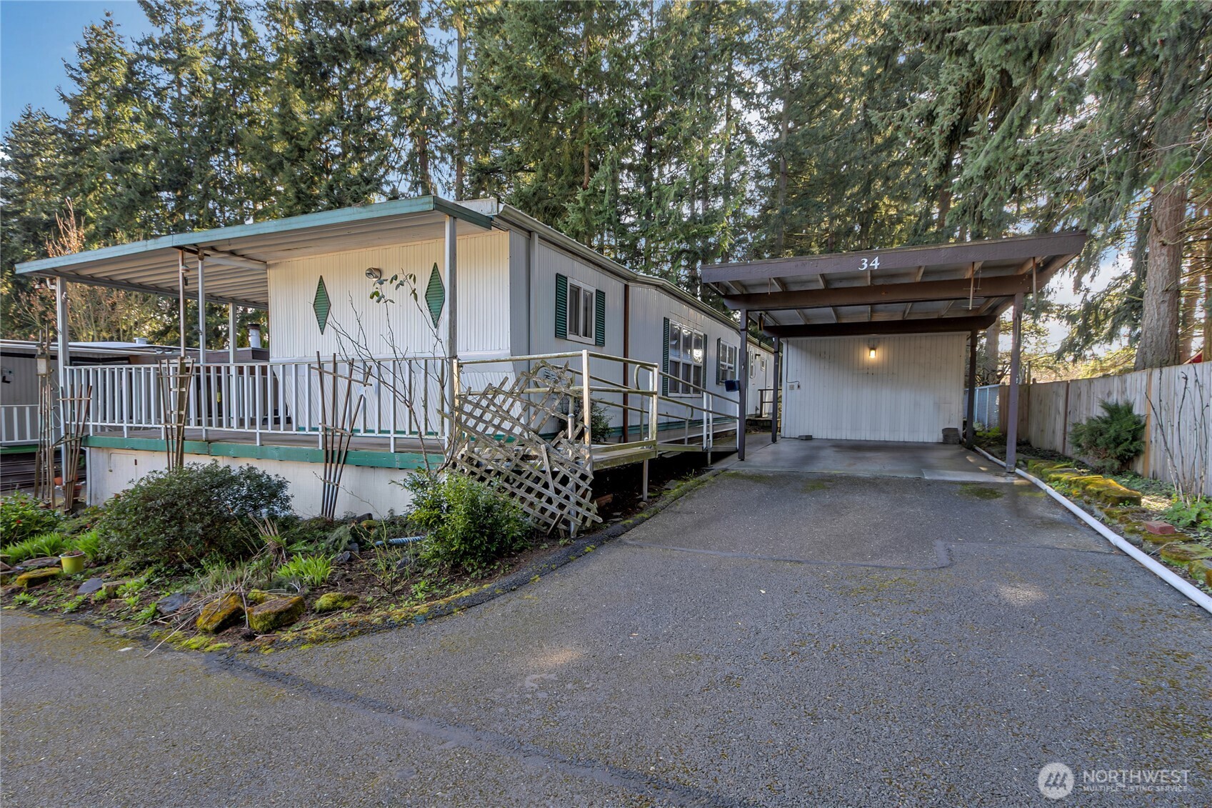 a backyard of a house with lots of green space and outdoor seating