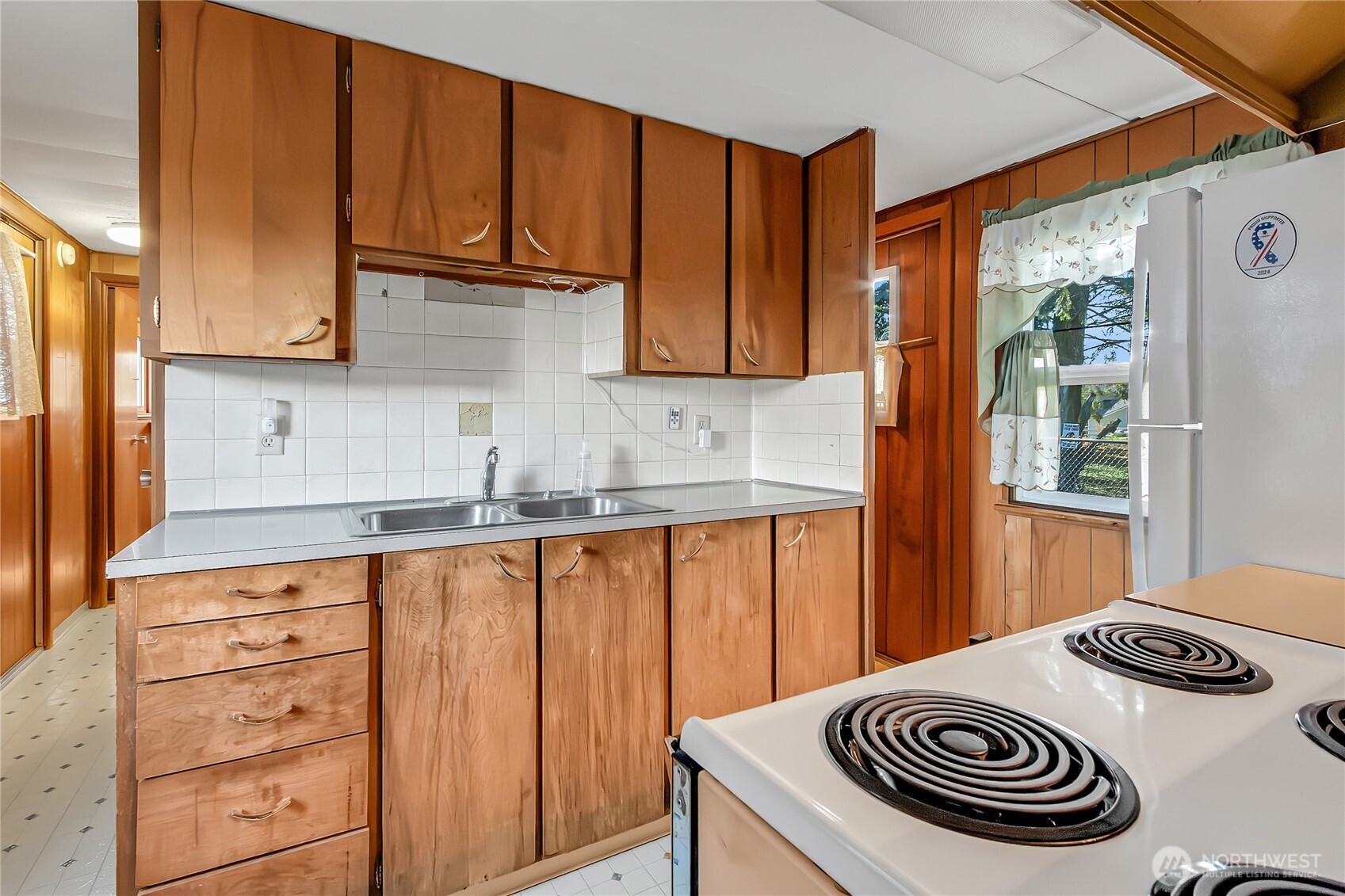 9314 Canyon Road East, Unit 34 Puyallup, WA 98371 - Photo 11 of 18 a kitchen with granite countertop a sink a stove and cabinets