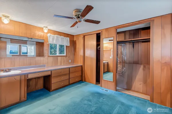 a large bedroom with a large bed and a chandelier