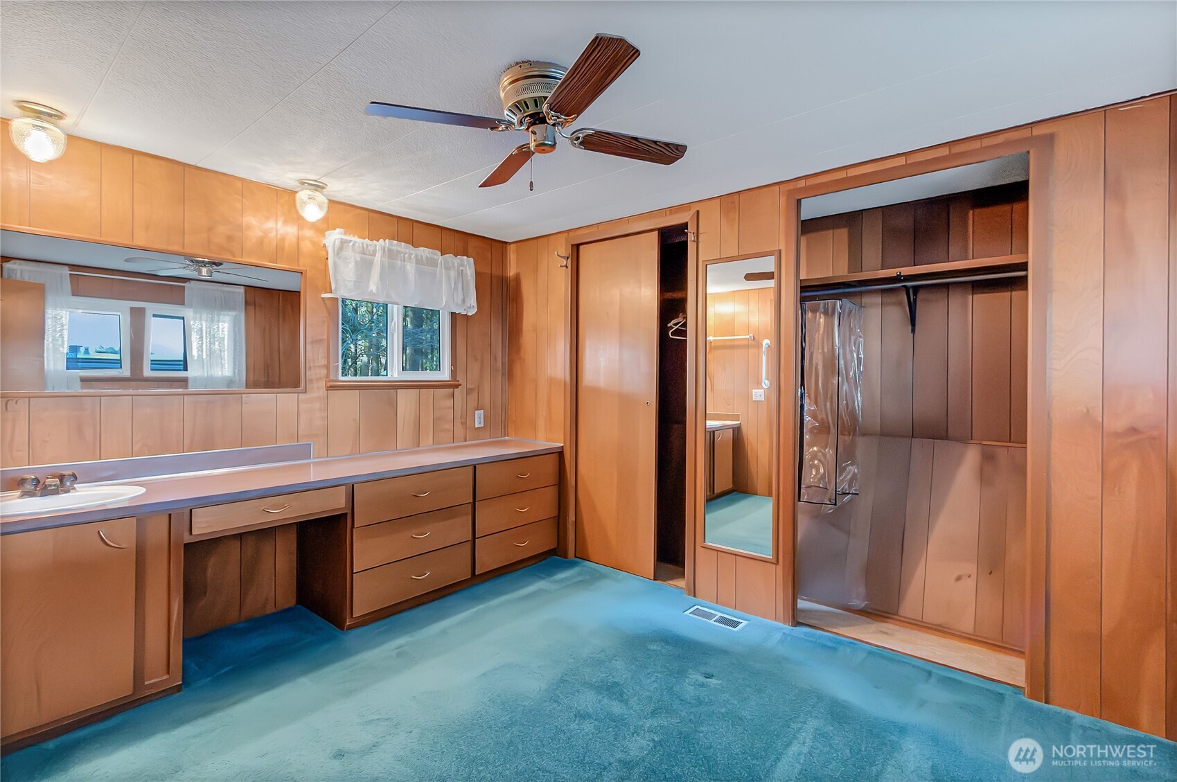 9314 Canyon Road East, Unit 34 Puyallup, WA 98371 - Photo 15 of 18 a large bedroom with a large bed and a chandelier