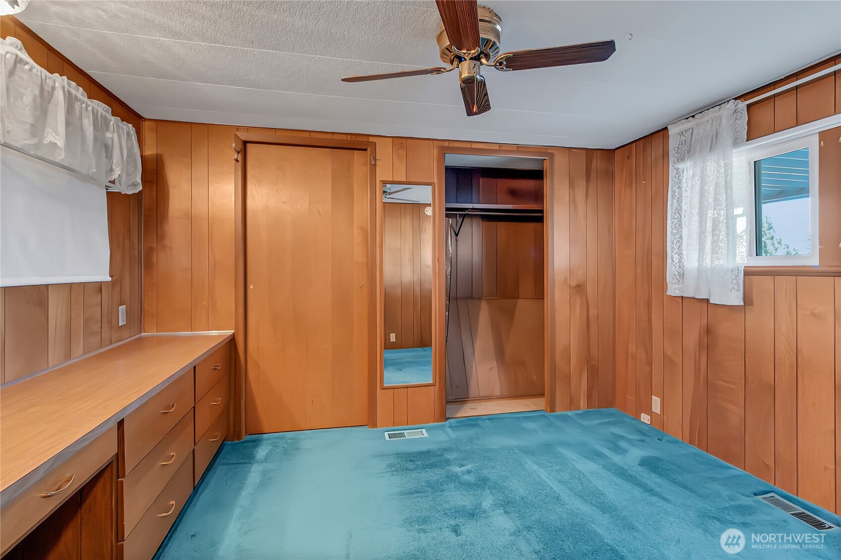 9314 Canyon Road East, Unit 34 Puyallup, WA 98371 - Photo 17 of 18 a view of an empty room with window and wooden floor
