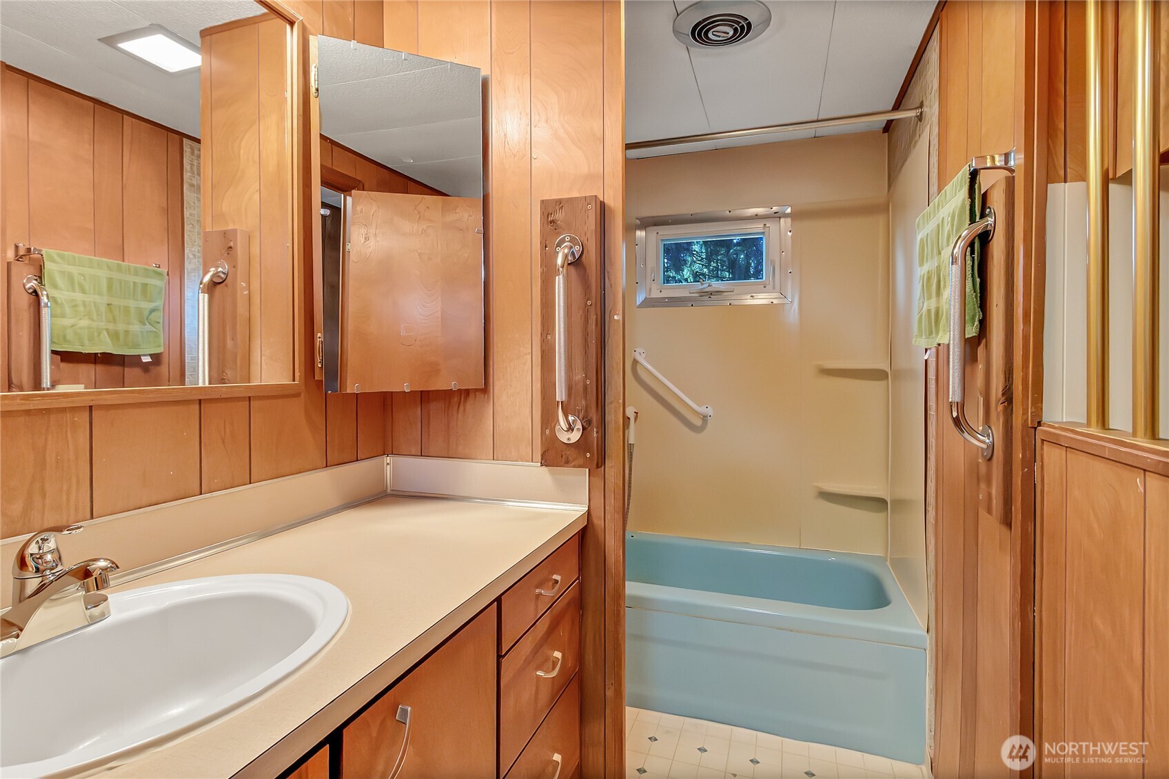 9314 Canyon Road East, Unit 34 Puyallup, WA 98371 - Photo 18 of 18 a bathroom with a granite countertop sink a mirror and a bathtub