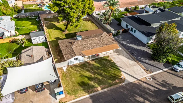 an aerial view of a house with a yard and trees