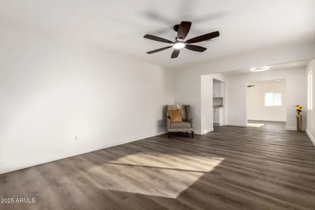 a view of a livingroom with wooden floor and window