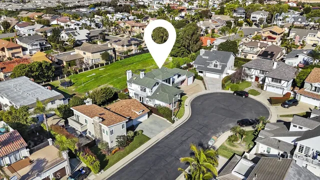 an aerial view of multiple houses with yard