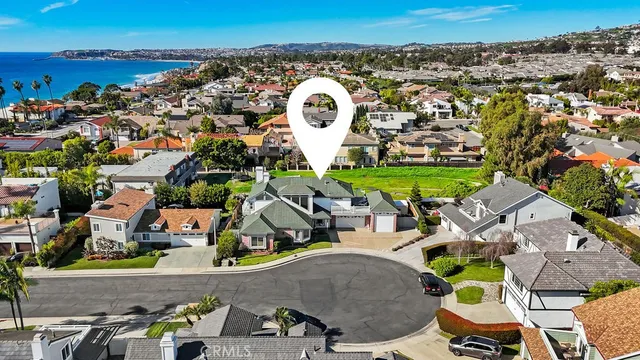 an aerial view of a house with a swimming pool outdoor seating and yard