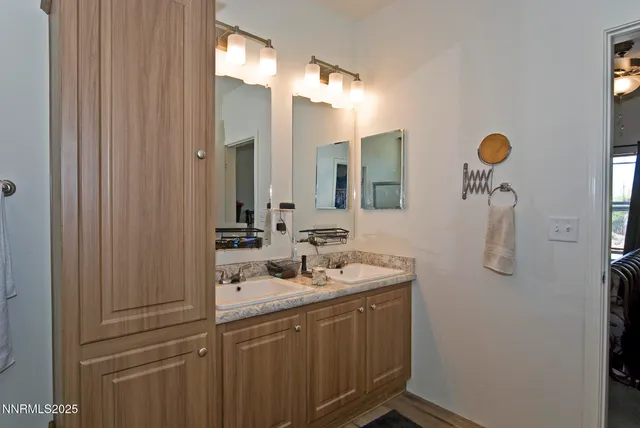 a bathroom with a sink vanity and mirror