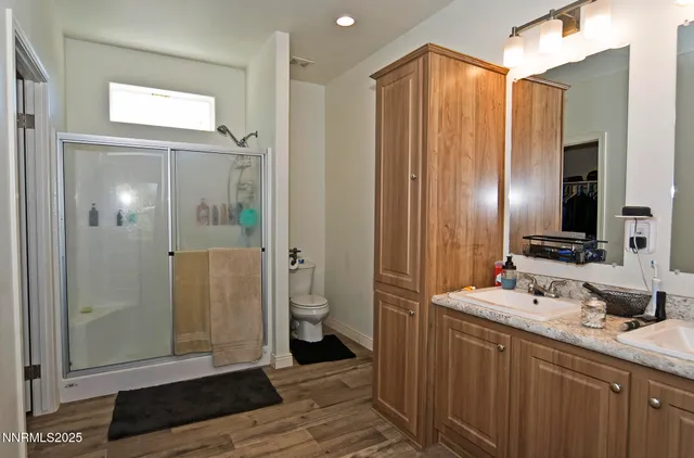 a bathroom with a sink a toilet and shower