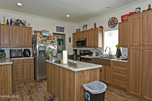 a kitchen with stainless steel appliances a refrigerator sink and cabinets
