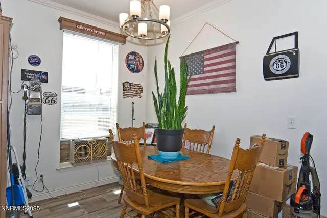 a view of a dining room with furniture window and wooden floor