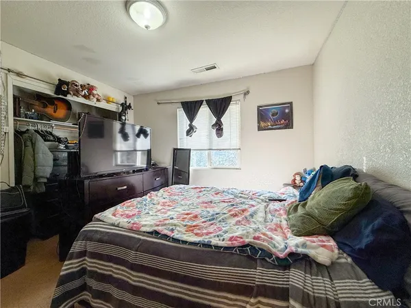 a bedroom with a bed and dresser