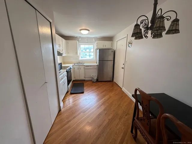 a view of a livingroom with furniture and hardwood floor