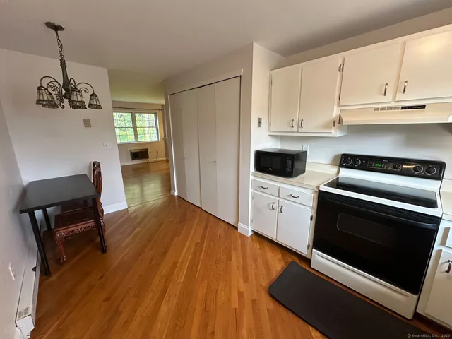 a kitchen with wooden floors and appliances