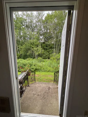 a view of a porch and floor to ceiling window
