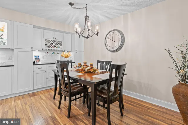a view of a dining room with furniture wooden floor and chandelier