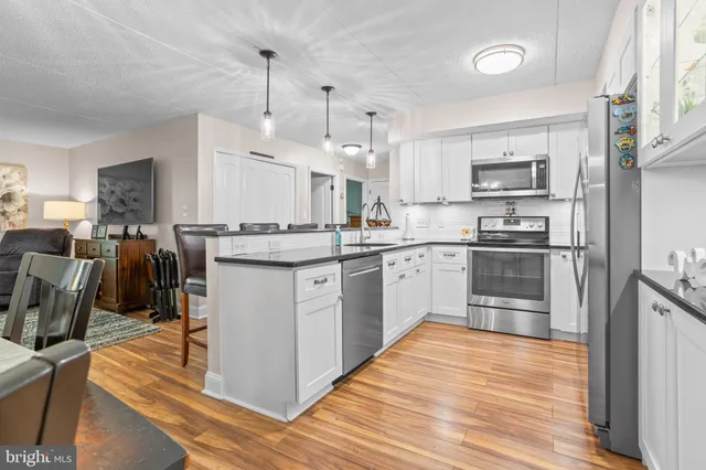 a kitchen with a refrigerator a sink and a stove