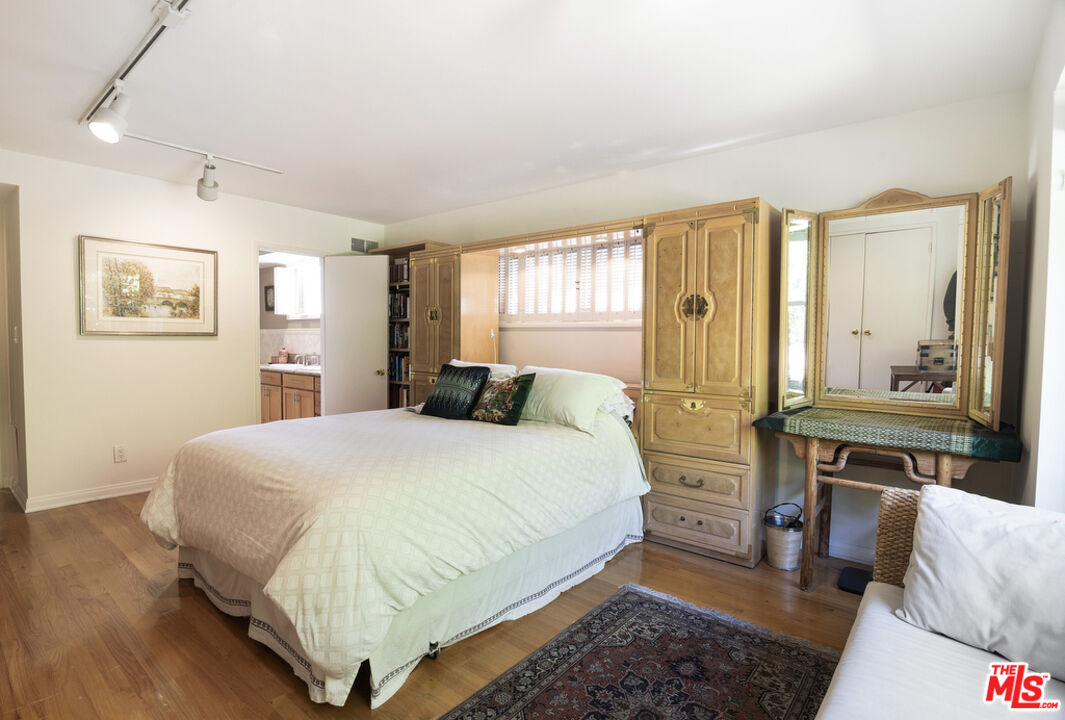9527 Oakmore Road Los Angeles, CA 90035 - Photo 16 of 29 a bed room with a bed and a couch