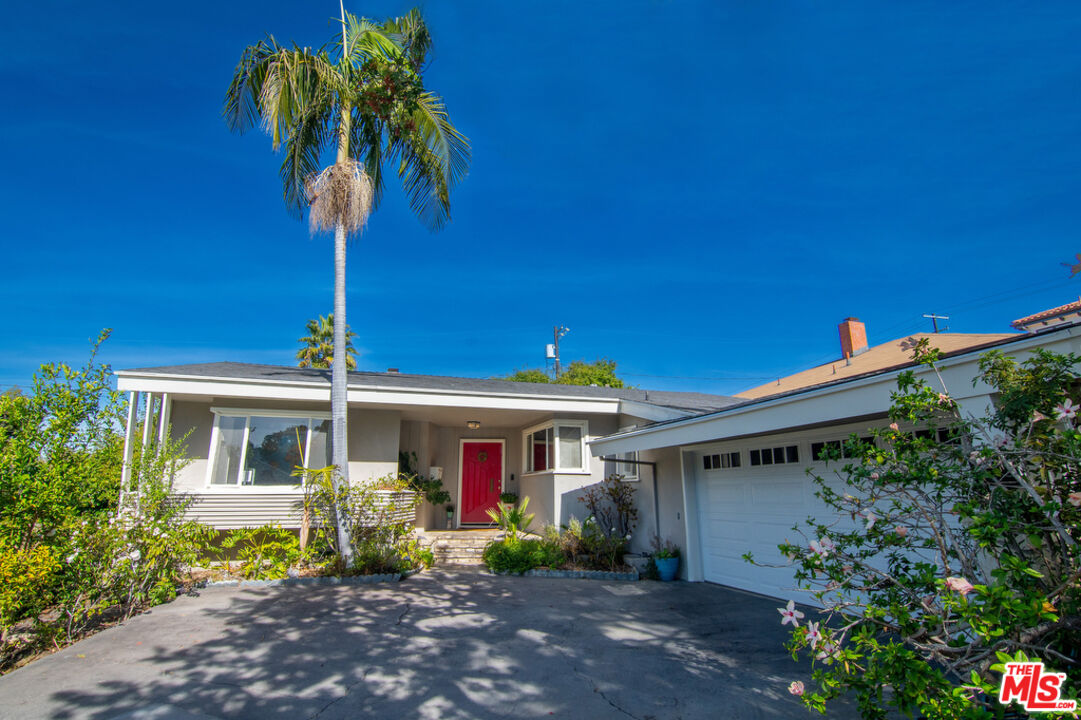 9527 Oakmore Road Los Angeles, CA 90035 - Photo 2 of 29 a front view of a house with garden