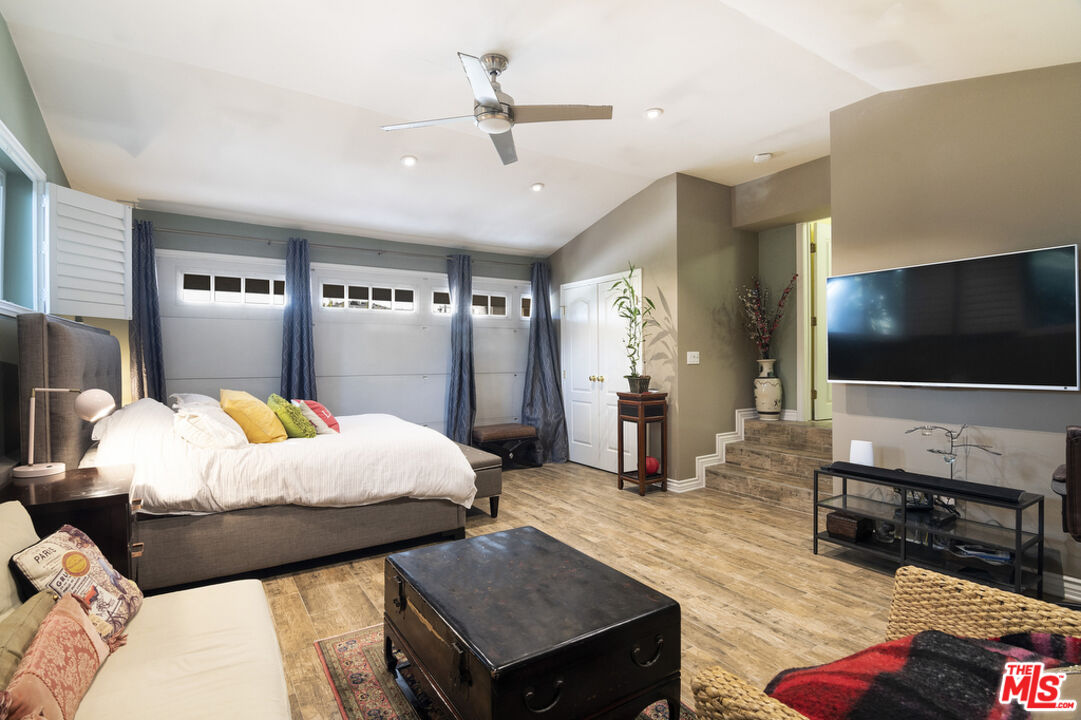 9527 Oakmore Road Los Angeles, CA 90035 - Photo 21 of 29 a bedroom with furniture and a flat screen tv