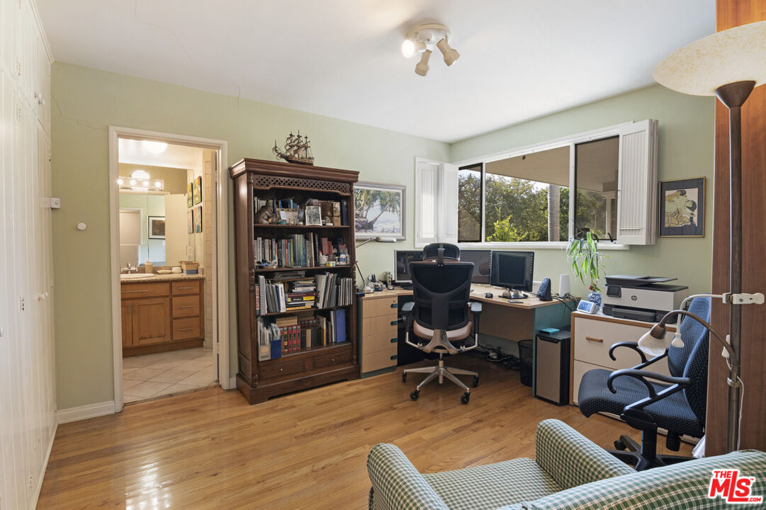 9527 Oakmore Road Los Angeles, CA 90035 - Photo 23 of 29 a work room with furniture and a book shelf