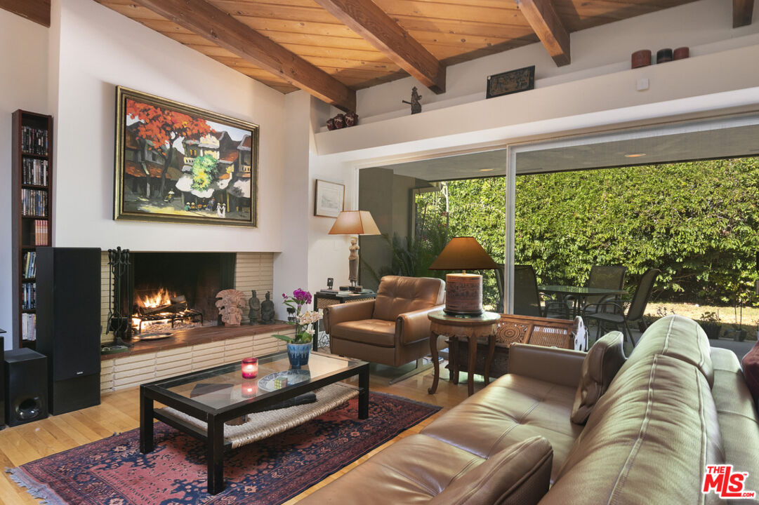 9527 Oakmore Road Los Angeles, CA 90035 - Photo 6 of 29 a living room with furniture a fireplace and a large window