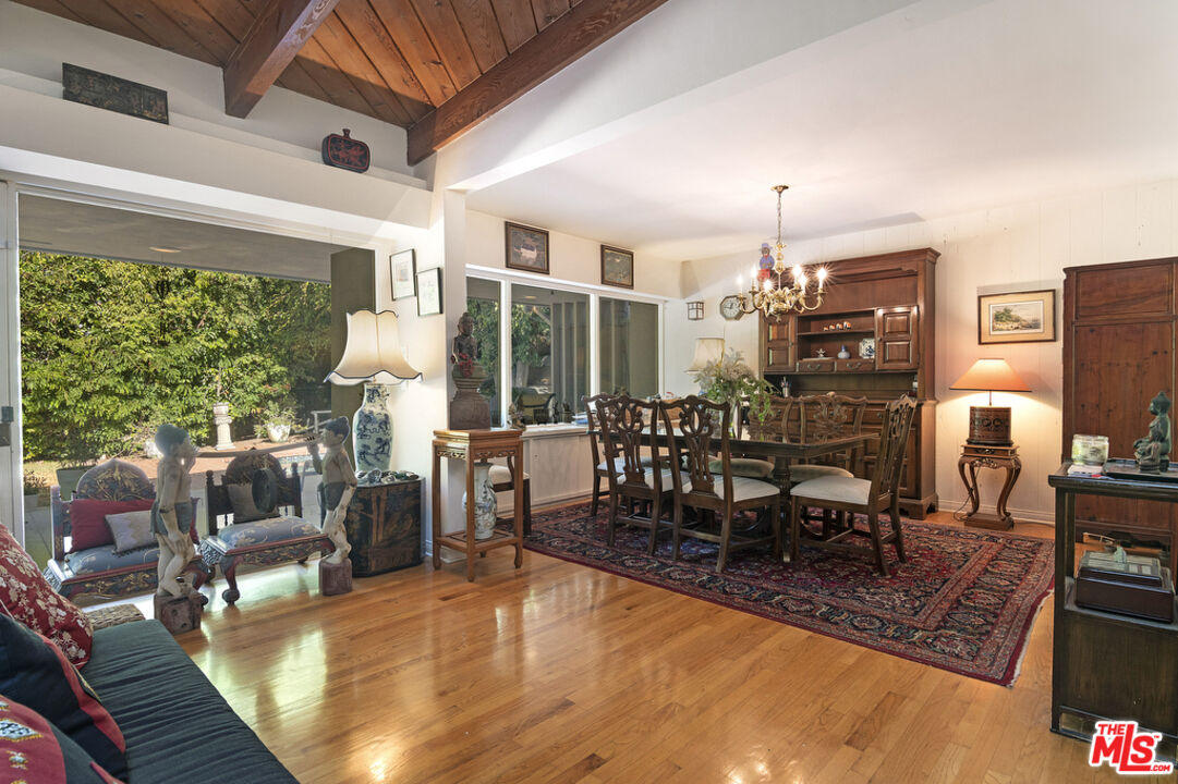 9527 Oakmore Road Los Angeles, CA 90035 - Photo 7 of 29 a dining room with furniture a chandelier and wooden floor