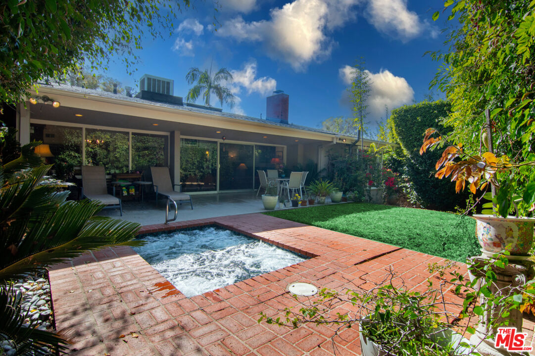 9527 Oakmore Road Los Angeles, CA 90035 - Photo 9 of 29 a view of a house with backyard sitting area and garden