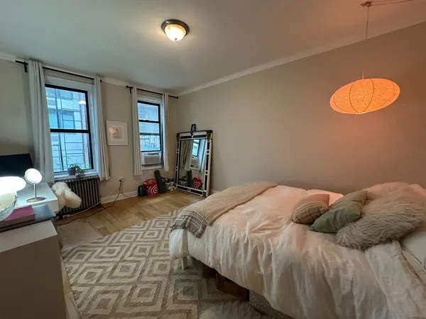 a bedroom with a bed and window