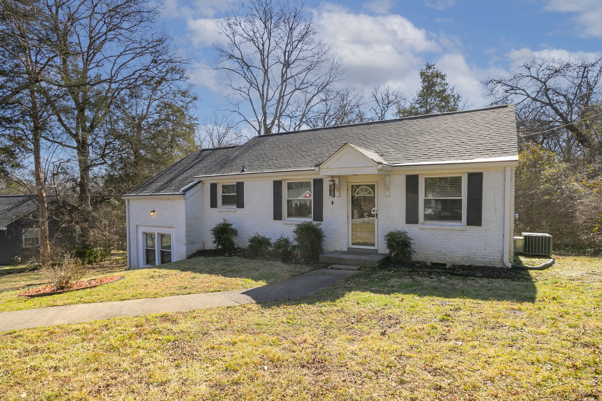 a view of a house with a yard covered in snow