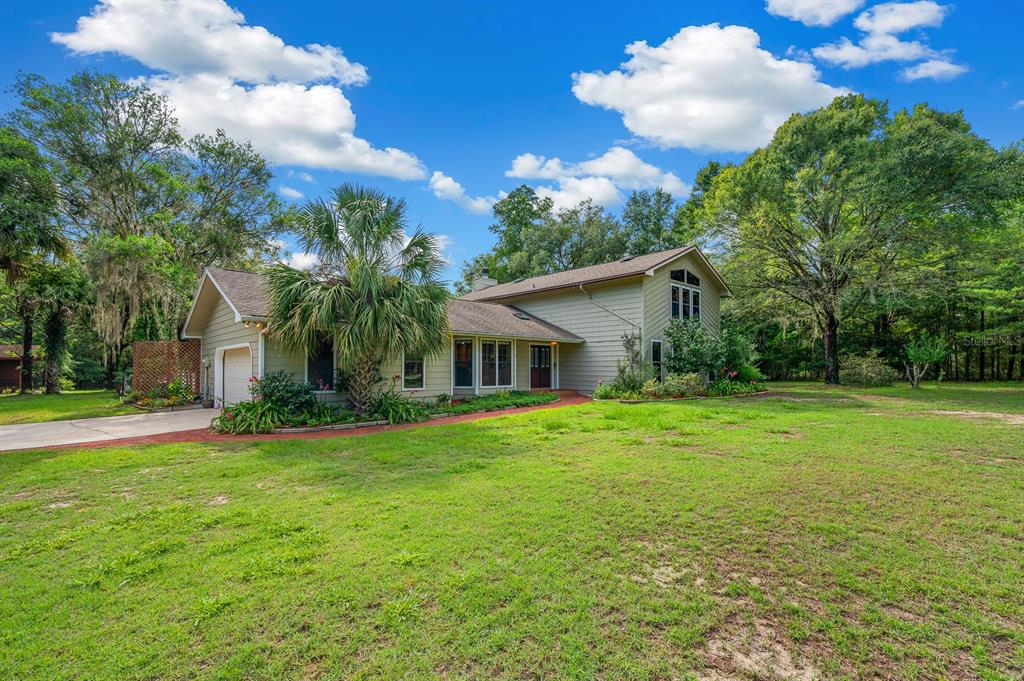 7201 Southwest 97th Lane Gainesville, FL 32608 - Photo 1 of 68 a front view of house with yard and green space