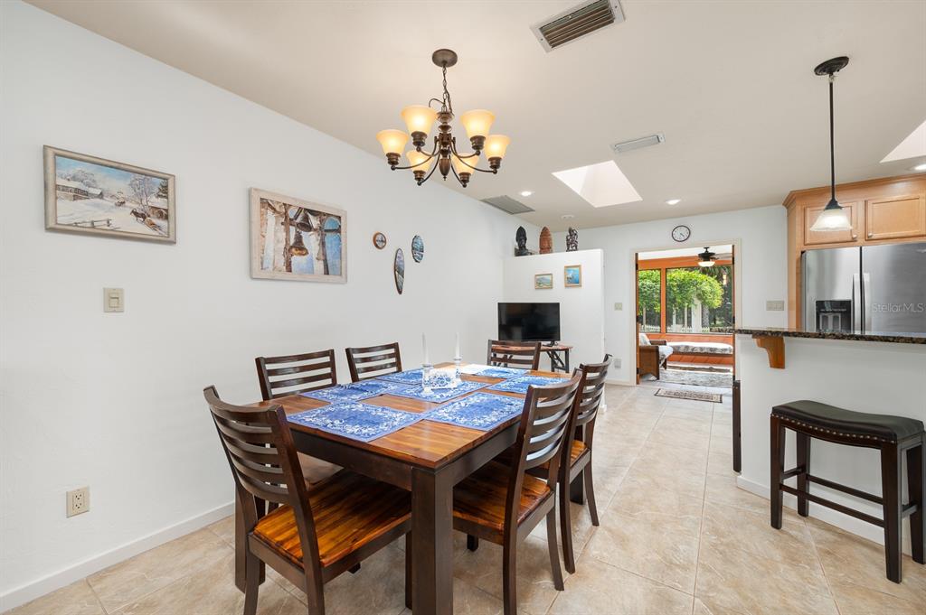 7201 Southwest 97th Lane Gainesville, FL 32608 - Photo 23 of 68 a view of a dining room with furniture and a chandelier
