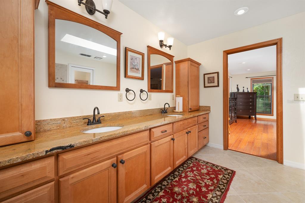 7201 Southwest 97th Lane Gainesville, FL 32608 - Photo 30 of 68 a spacious bathroom with a granite countertop sink and a mirror