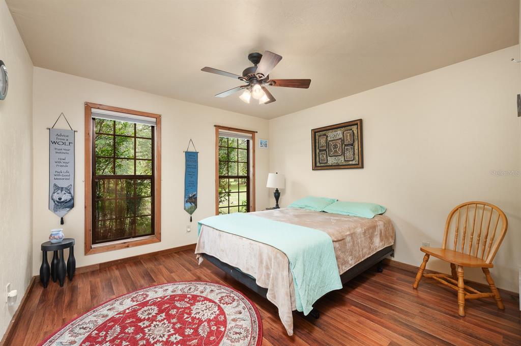 7201 Southwest 97th Lane Gainesville, FL 32608 - Photo 40 of 68 a bedroom with a bed and a chair