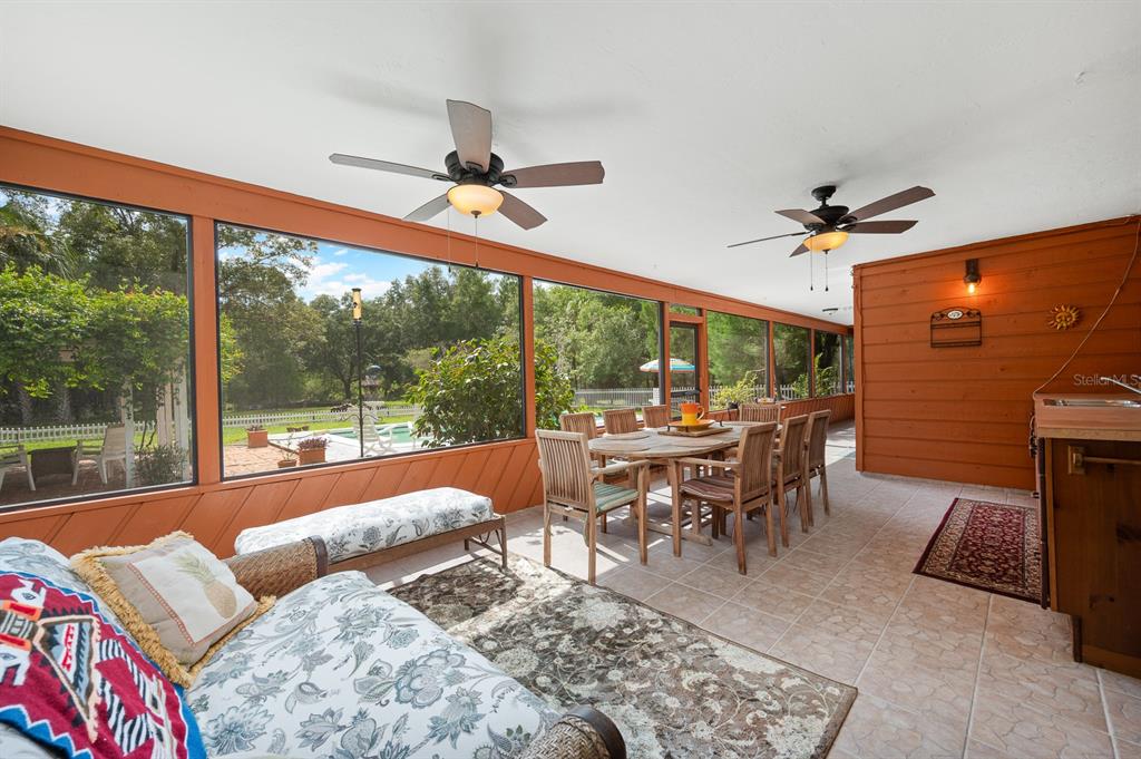 7201 Southwest 97th Lane Gainesville, FL 32608 - Photo 43 of 68 a living room with furniture a ceiling fan and a large window