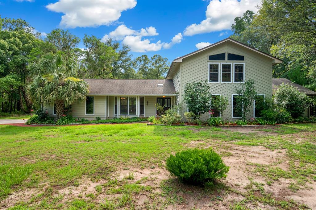 7201 Southwest 97th Lane Gainesville, FL 32608 - Photo 6 of 68 a front view of a house with a yard