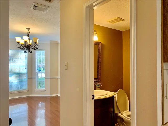a view of a livingroom with a window and a chandelier