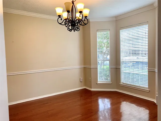 a view of a living room with wooden floor