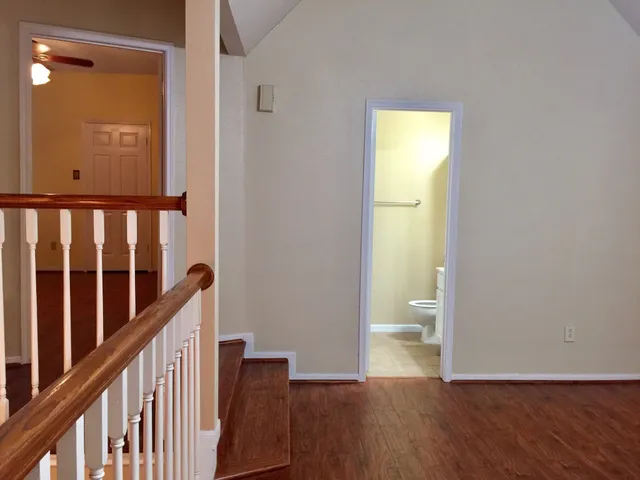 a view of an empty room with wooden floor