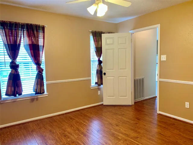 a view of a backyard with a garden and tree