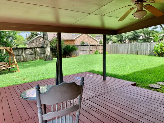 a view of a patio with a table chairs and a backyard