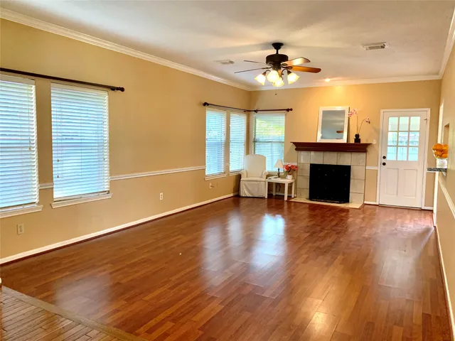 a view of a livingroom with furniture fireplace and wooden floor