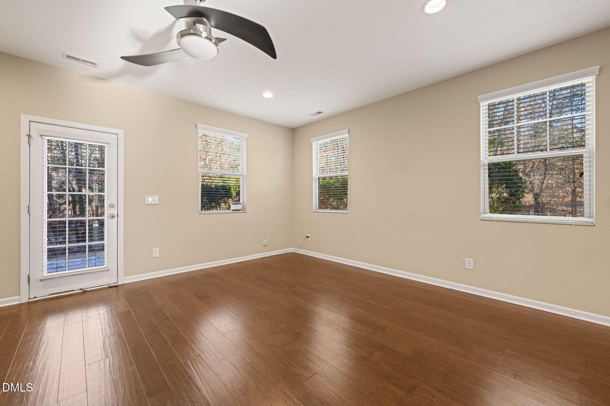 502 Libson Street Durham, NC 27703 - Photo 11 of 43 a view of an empty room with a window and wooden floor