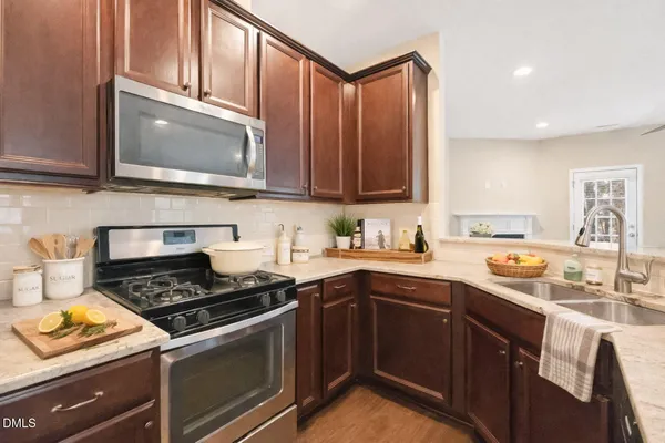 a kitchen with a refrigerator stove and microwave