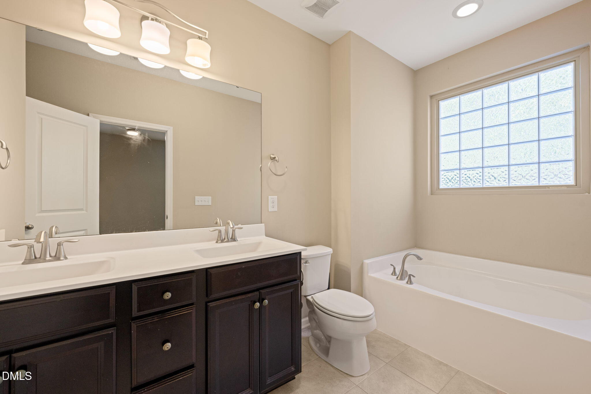 502 Libson Street Durham, NC 27703 - Photo 23 of 43 a bathroom with a bathtub sink vanity mirror and toilet