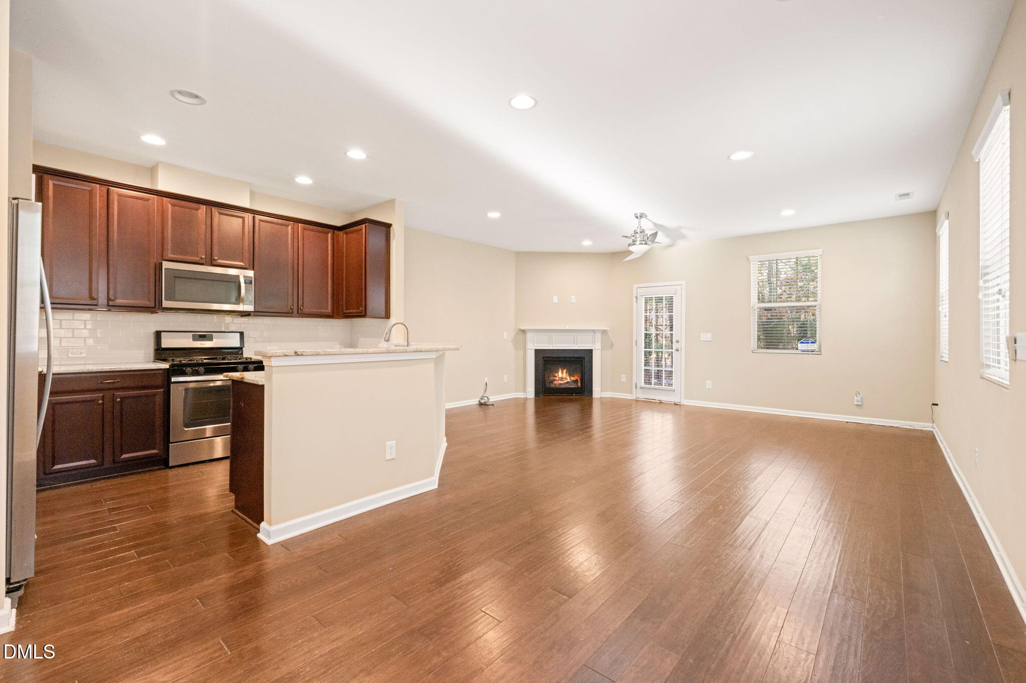 502 Libson Street Durham, NC 27703 - Photo 7 of 43 a kitchen with kitchen island granite countertop wooden floors a stove and a microwave